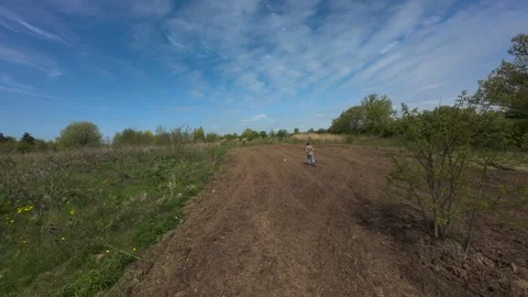 Drone view of a man walking and spreading seeds by hand on a food plot Stock Footage 341758060