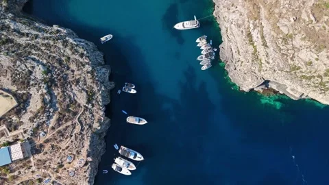 Drone view of Mġarr ix-Xini Bay, Gozo, boats in clear turquoise inlet water Stock Footage 341712643