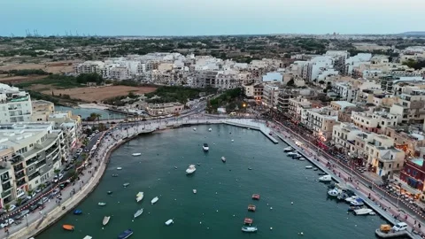 Drone view of Marsaskala Bay harbor with boats by the Malta promenade Stock Footage 342610996