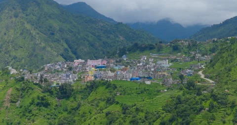 Drone view of Martadi town framed by lush green mountain slopes in Bajura, Nepal Stock Footage 346032787