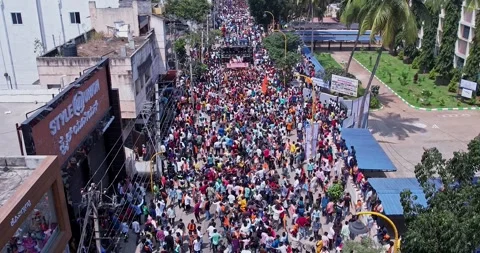 Drone view of Massive Crowd Dancing Joyfully During Vibrant Ganesha Immersi.. Stock Footage 340084382
