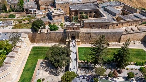 Drone view of the mdina gate, Malta in small fortified city with green grass Fotos de archivo