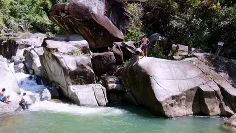 Drone View of Men Jumping into Rainforest Lake Stock Footage 202073914