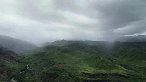 Drone view of misty clouds over the green mountains of Waimea Canyon Stock-Footage 347825869