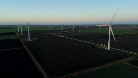 Drone view of modern electricity generators rotating slowly in the evening Stock Footage 332374117