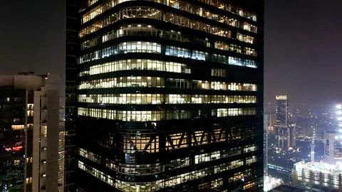 Drone view of modern skyscraper offices illuminated at night Foto stock