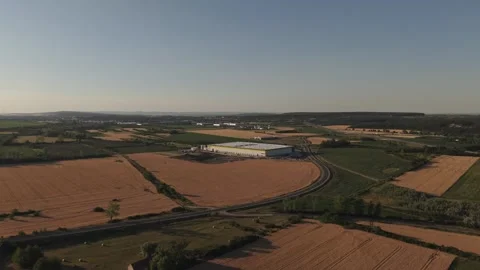 A drone view of a modern warehouse and logistics facility surrounded by Stock Footage 338191693