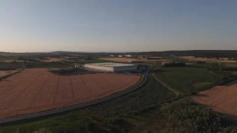 Drone view of a modern warehouse and logistics facility surrounded by Stock Footage 338192218