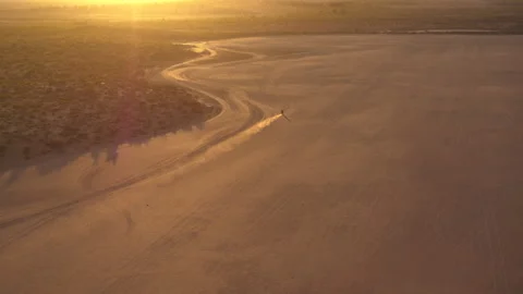 Drone view of a motorcycle in the desert Stock Footage 264075595