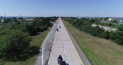 Drone view of motorcycles riding down highway Stock Footage 120708415