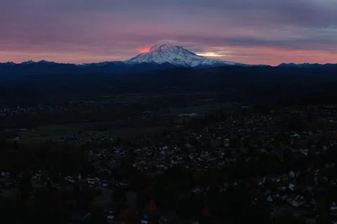 Drone View of Mount Rainier Over Suburban Neighborhood at Twilight in Washing Stock Photos