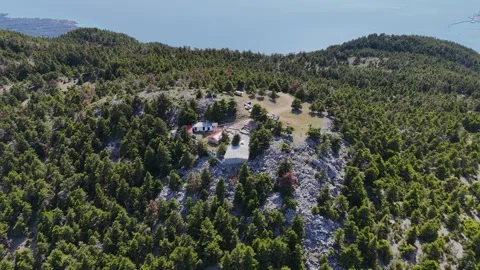 Drone view of mountain chapel on forest peak in Greece Stock-Footage 332821520
