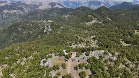 Drone view of mountain forest with chapel and cars in Greece Stock-Footage 332822459