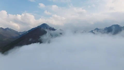 Drone view of mountain landscape with beautiful clouds against a bright blue sky Stock Footage 312378714