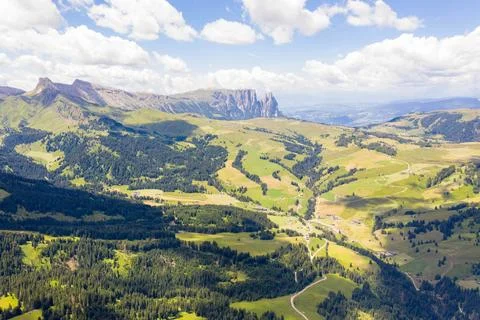Drone view of mountain meadows and hiking path through it Stock Photos