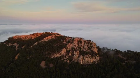 Drone view of mountain peak surrounded by clouds in Spain Stock Footage 314604816