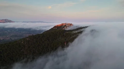 Drone view of mountain peak surrounded by clouds in Spain Stock Footage 314605031