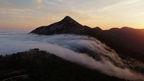 Drone view of mountain peak surrounded by clouds in Spain Stock Footage 314605135
