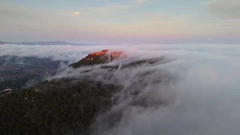 Drone view of mountain peak surrounded by clouds in Spain Stock Footage 314605216