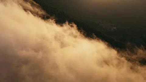 Drone view of mountain peaks in clouds at sunset Stock Footage 314605618