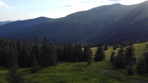 Drone View of Mountain Peaks at Dusk with Golden Sunset Light Stock Footage 339660374