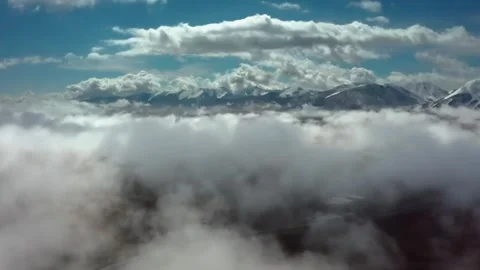 Drone View of Mountain Range Partially Obscured by Clouds in Kyrgyzstan Stock Footage 306571991