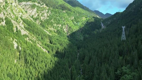 Drone view of mountain valley with forest and power line tower Stock Footage 318619130