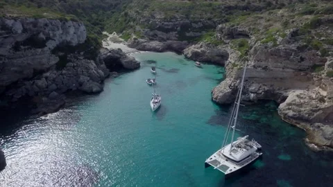 Drone view moving away from a calm bay with few boats on the Mediterranean sea. Stock Footage 221737818