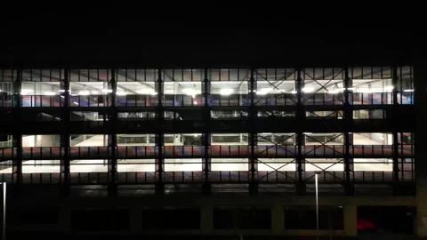 Drone view of a multi-level car park at night. Video stock 252554364