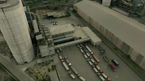 Drone view of multiple lorries queued outside cement factory for transportation Stock Footage 308720263
