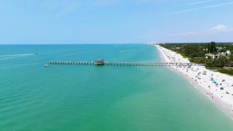 Drone view of Naples, Florida with wide stretch of white sandy beach and calm Stock Footage 273869476