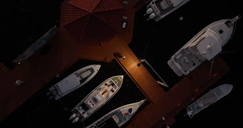 Drone View of Night Ocean Pier with Boats Preparing for Fishing Stock Footage 300361966