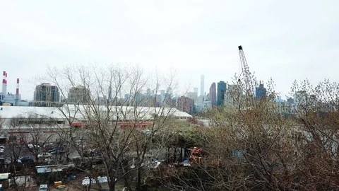 Drone view of NYC skyline from Queens treeline Stock Footage 106413817