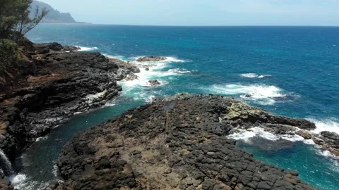 Drone view of the ocean and stone coastline at Kauai, Hawaii, USA Video stock 135951183