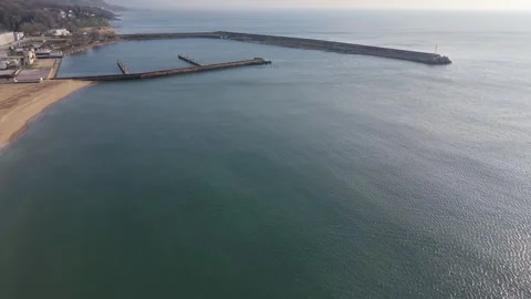 Drone view of ocean with harbor breakwater and tranquil waves Stock-Footage 332129227
