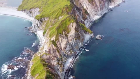 Drone view of ocean waves and green cliffs in summer Stock Footage 311989767