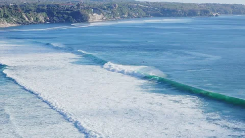 Drone view with ocean waves and surfers in ocean in Bali Stock Footage 345602882