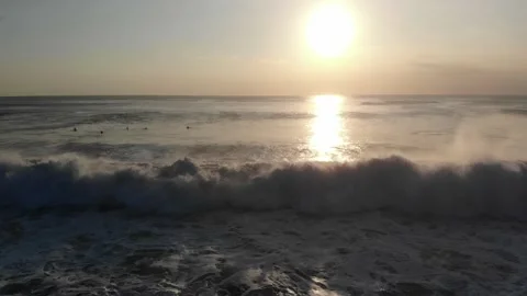 Drone view of ocean waves crashing at sunset, symbolizing natural beauty Stock Footage 155680417