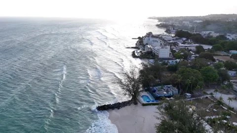Drone view of ocean waves crashing onto a rocky pier during twilight. Coastal Video stock 336695927