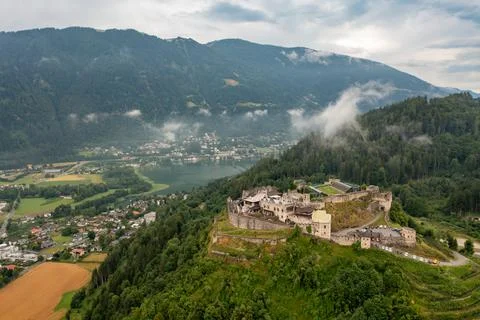 Drone view of the old castle in Austria, Tyrol. Mountain lake in fog Stock Photos