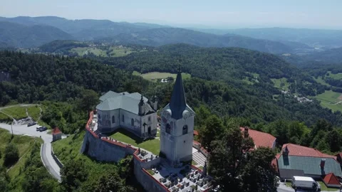 A drone view of an old church located on a hill. The camera moves smoothly c Stock Footage 247119934