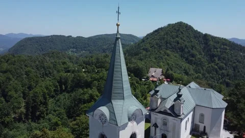 A drone view of an old church located on a hill. Camera slides up. Zasavje H Stock Footage 247119935