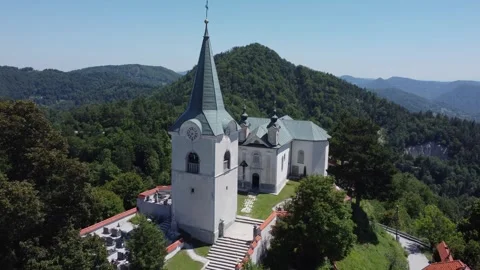 A drone view of an old church located on a hill. The camera moves smoothly f Stock Footage 247119973
