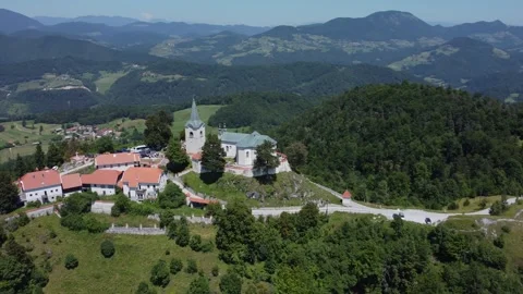 A drone view of an old church located on a hill. The camera moves smoothly t Stock Footage 247120375