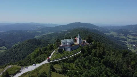 A drone view of an old church located on a hill. The camera moves smoothly t Stock Footage 247120437