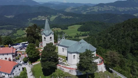 A drone view of an old church located on a hill. The camera slowly zooms out Stock Footage 247120836