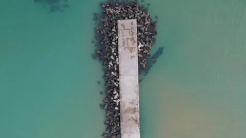 Drone view of old pier remains surrounded by clear green water Video stock 322537953