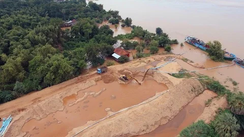 Drone view of operation of pumping sand out of a dredging boat through a pipe Stock Footage 86978500