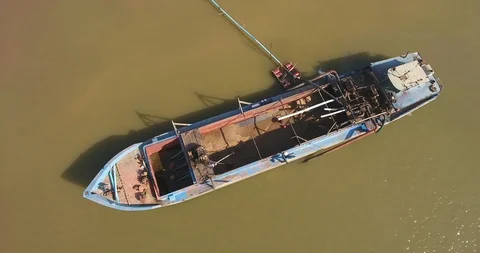 Drone view of an operation of pumping sand out of a dredging boat through a pipe Stock Footage 101929553