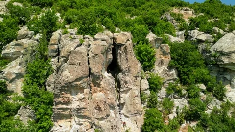 Drone view over Ancient Thracian sanctuary - Utroba cave above Kardzhali dam. Stock Footage 256037740